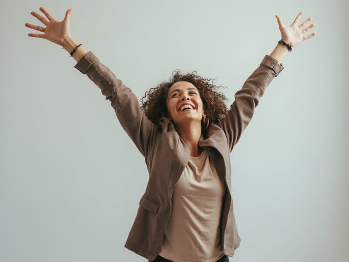 Empowering studio portrait of a person with growing confidence, symbolized by upward movement