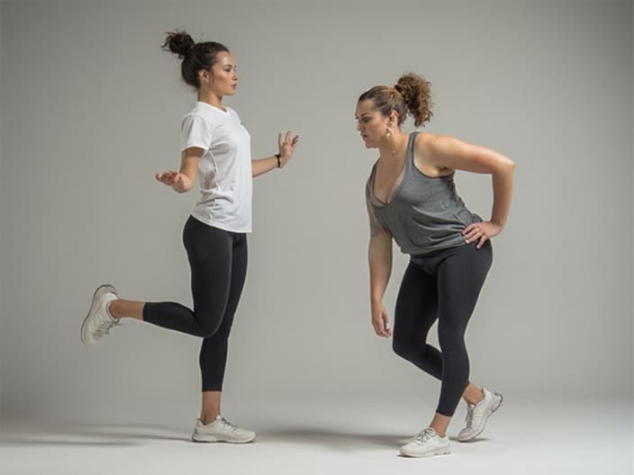 Studio shot of a fitness instructor demonstrating simple exercises